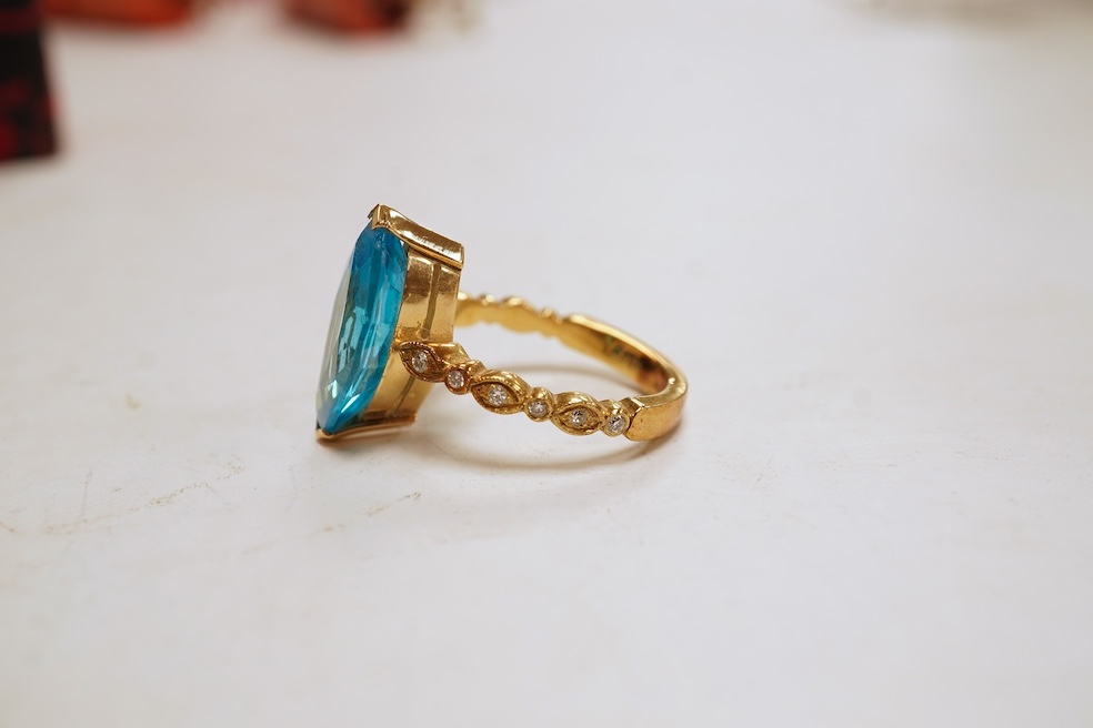 A cubic zirconia and diamond ring, set with a marquise-shaped blue cubic zirconia, to shoulders set with brilliant-cut diamonds, mounted in gold, size Q1/2, stamped 585, gross weight 8 grams, Condition: minor discolorati